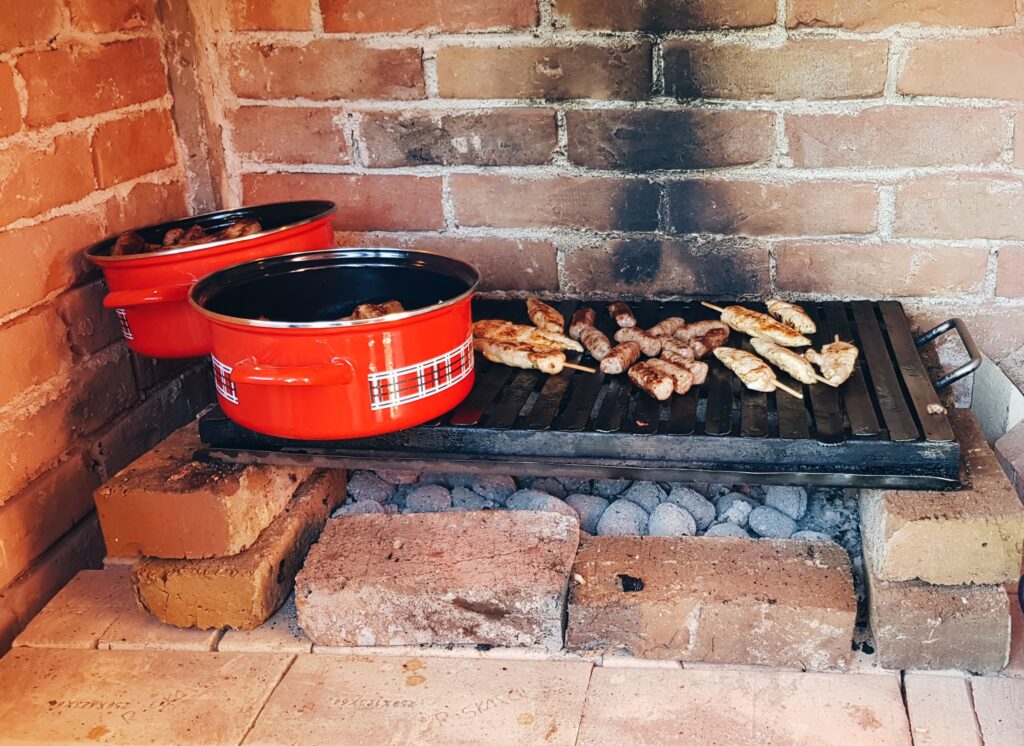 Meat on Grill Inside a Brick Oven