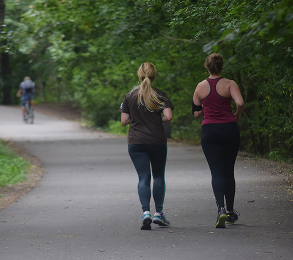 Two women jogging together.