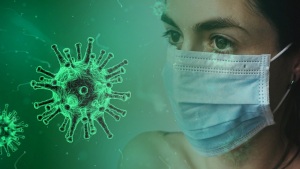 Image of a young woman wearing an examination mask with a graphic rendering of a virus cell superimposed.