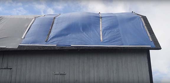 Blue tarp covering hole in roof